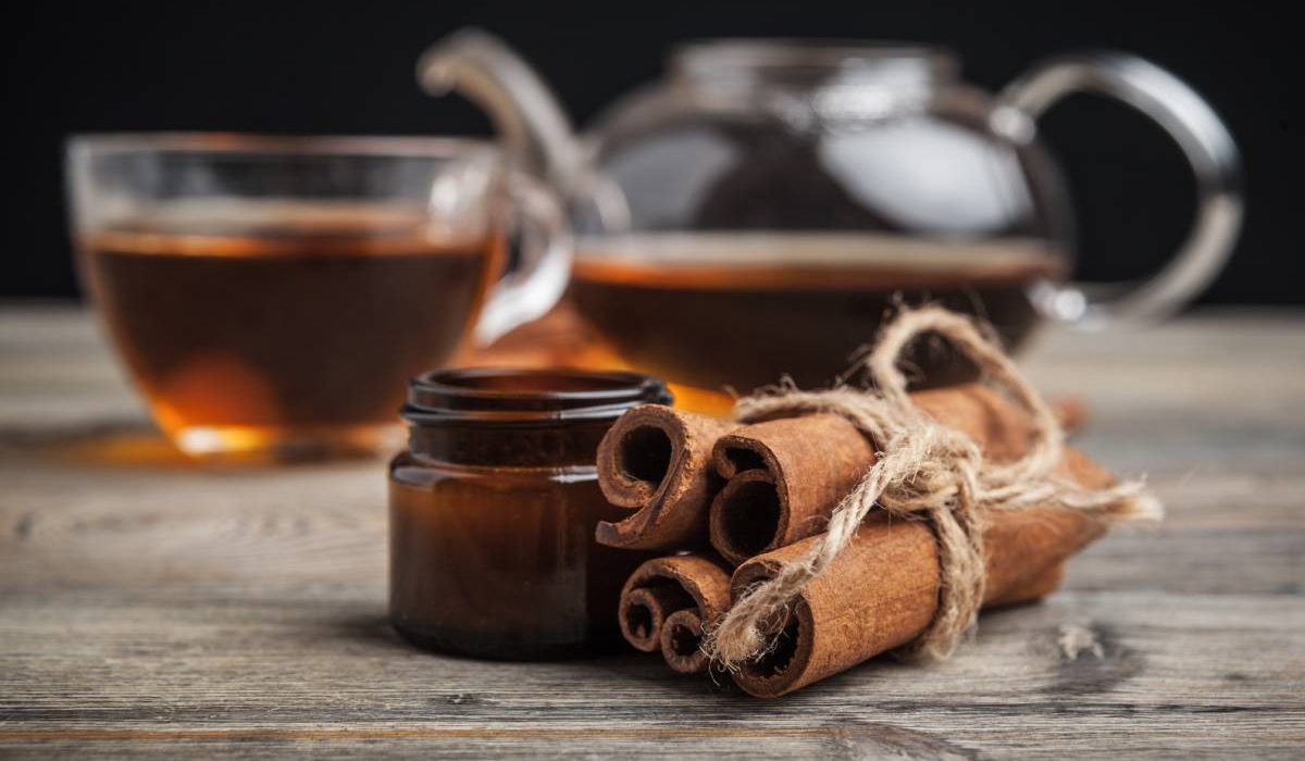 aromatic hot cinnamon tea on wooden table