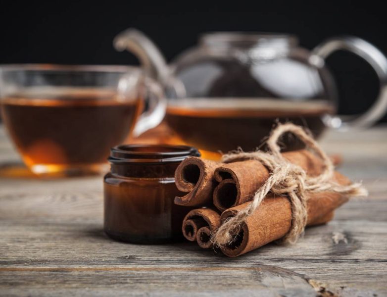 aromatic hot cinnamon tea on wooden table