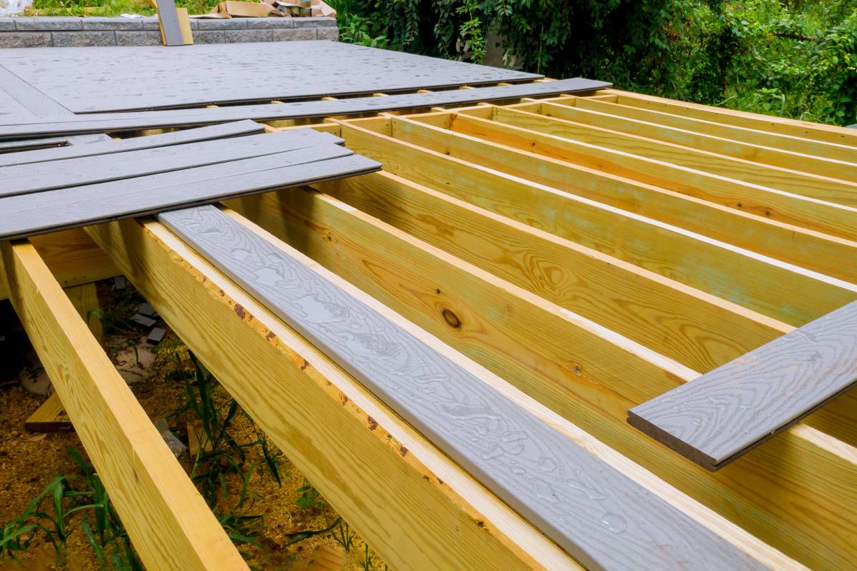A new wooden, timber deck being constructed. it is on the decking. New deck patio