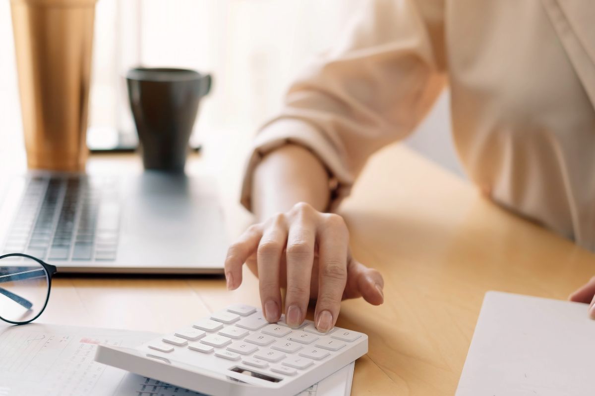 Close up view of bookkeeper or financial inspector hands making report, calculating or checking balance. Home finances, investment, economy, saving money or insurance concept