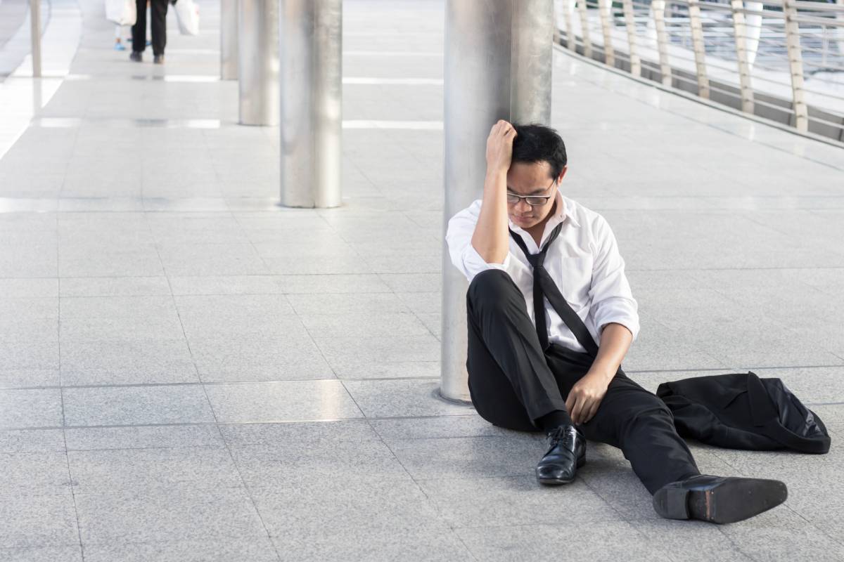 desperate and unemployed people, Economic downturn concept, frustrated man sitting on street, walkway after finding no job
