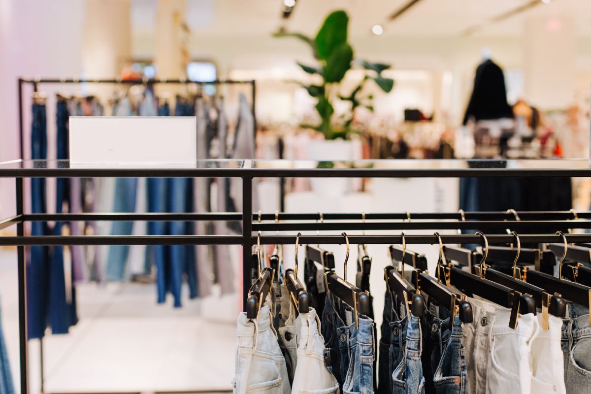 sale assortment denim collection on the stand in a stylish boutique shop selection
