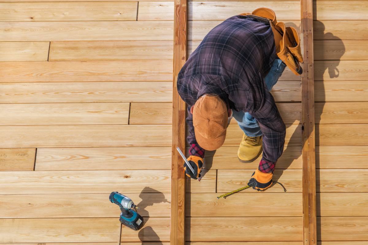 Caucasian Worker Building Wooden Deck For His Backyard Garden. Top View.